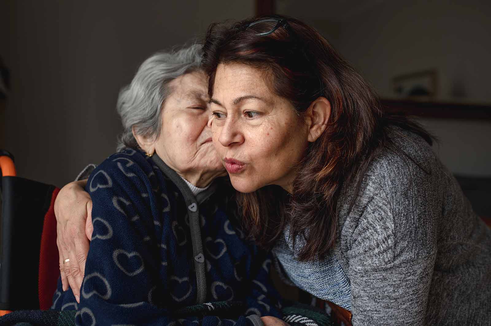 Elderly mother and daughter hugging