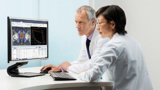 Two doctors looking at Monaco Planning Screen on a monitor