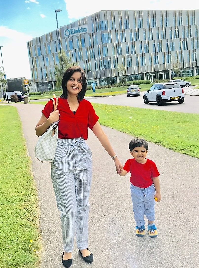 Sonal and her son, Ansh, in front of Elekta's Cornerstone campus in Crawley, UK