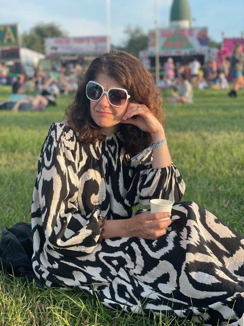 Kerry Sitting in a Park Wearing Sunglasses