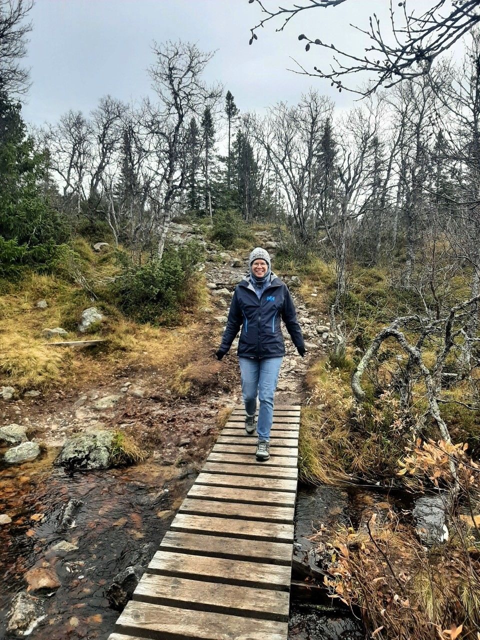 Lyne Walking a Wooden Path Through the Woods