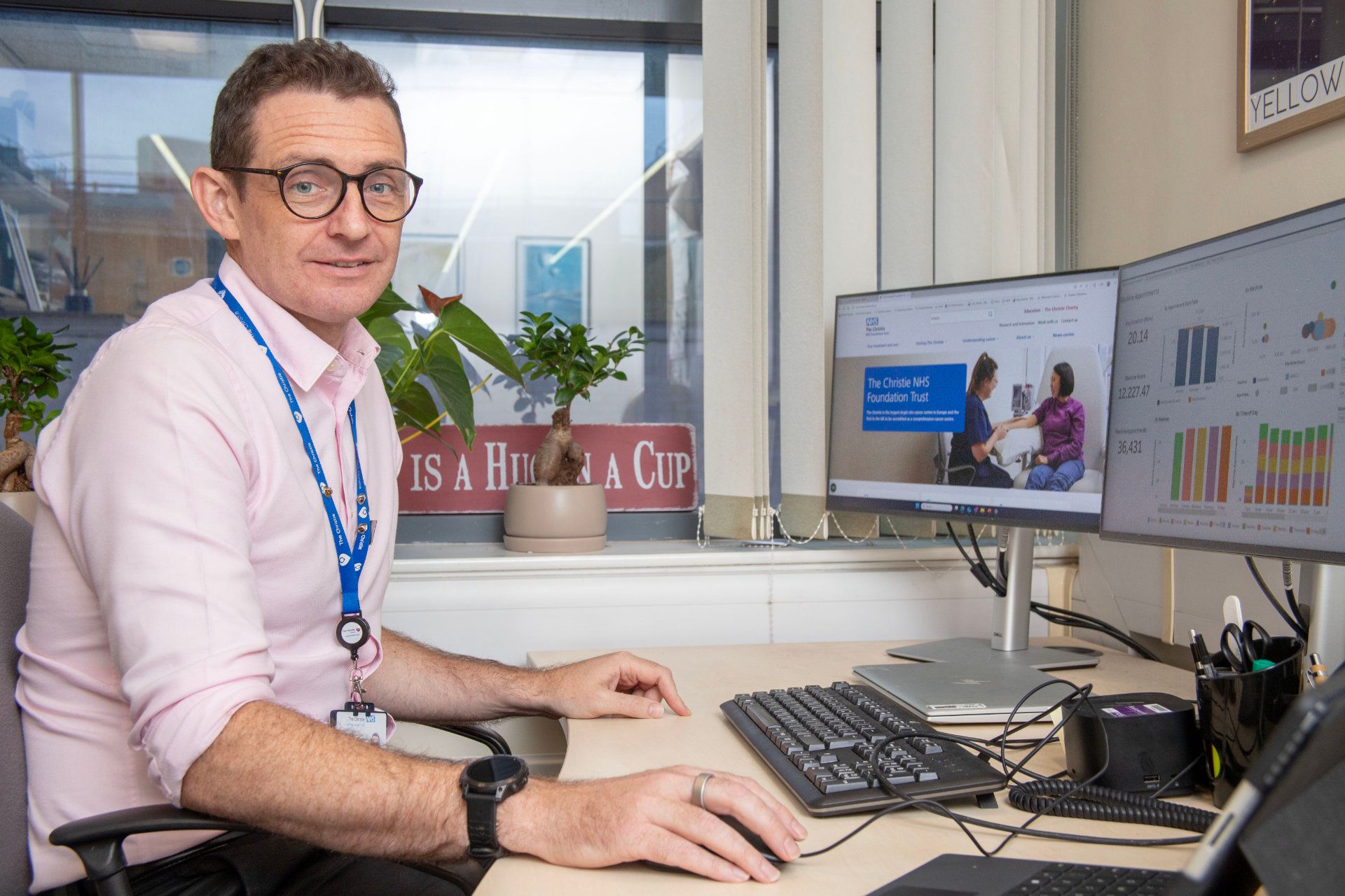 Elekta Pr John Archer Sat at His Desk