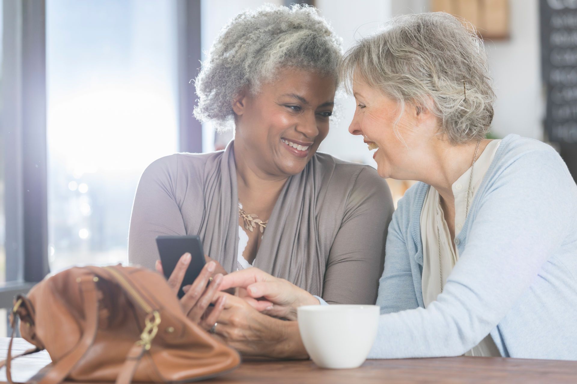 Two Elderly Women Looking at a Phone