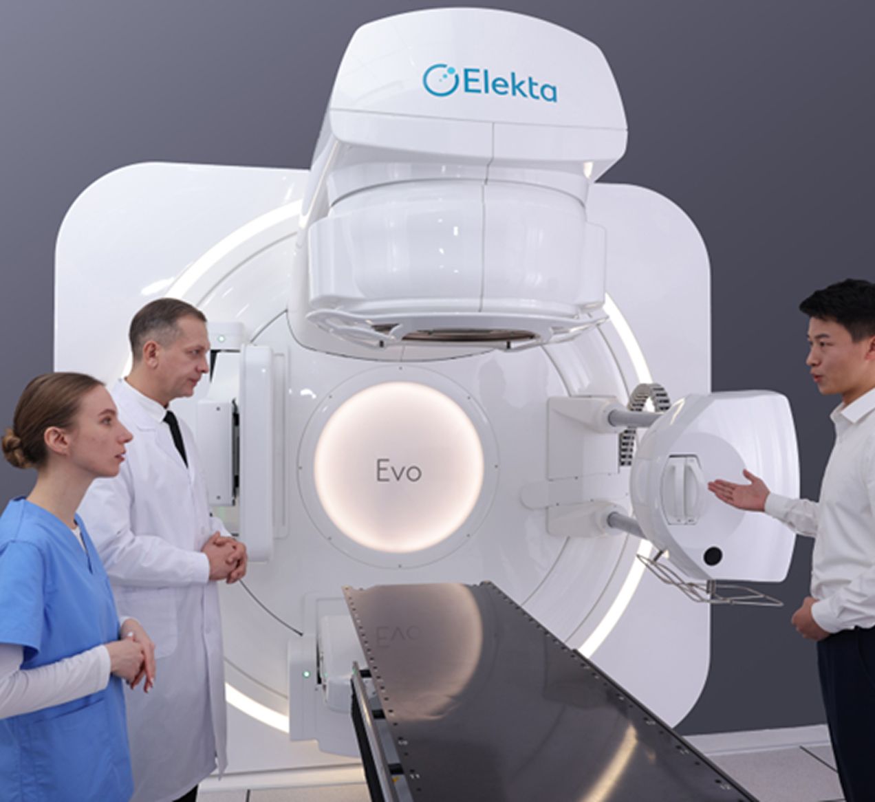 Clinitians Standing Talking Around Elekta Evo