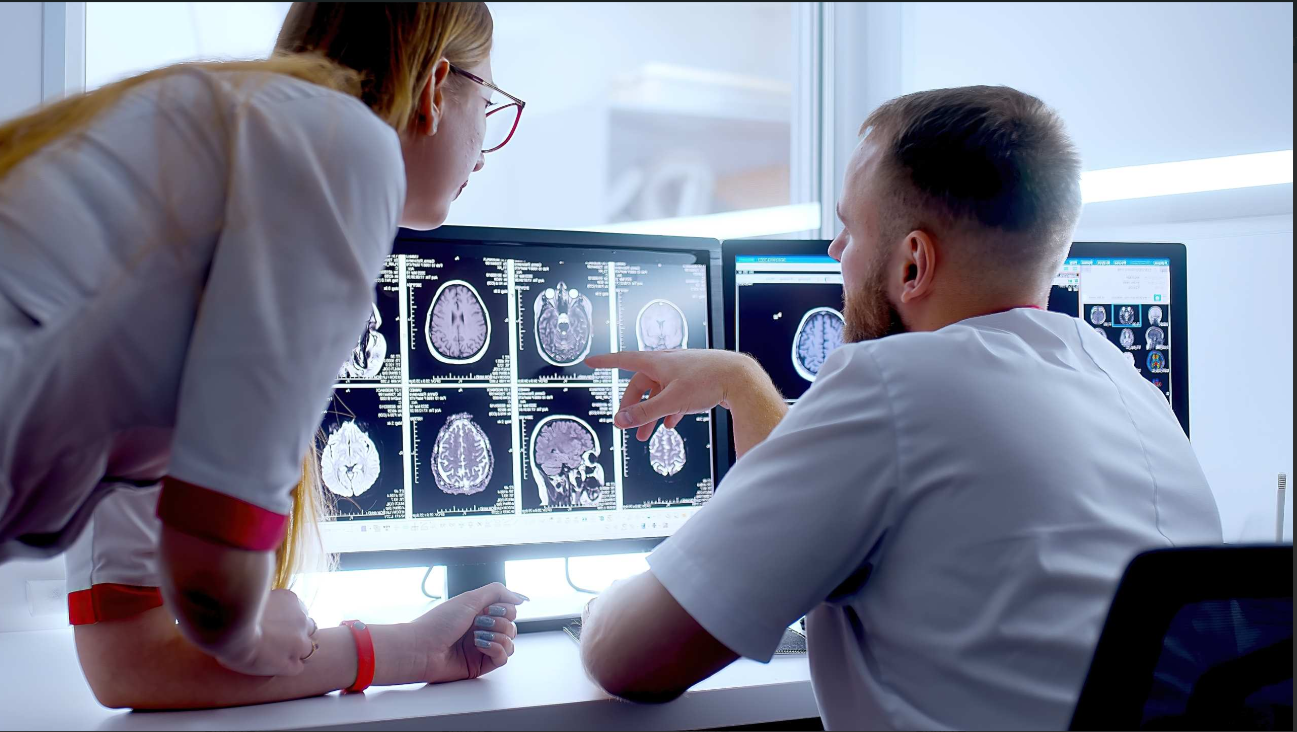 Clinicians reviewing medical images on monitors