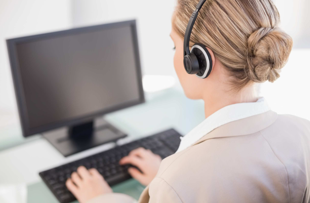 Consultant supporting a clinician at a workstation