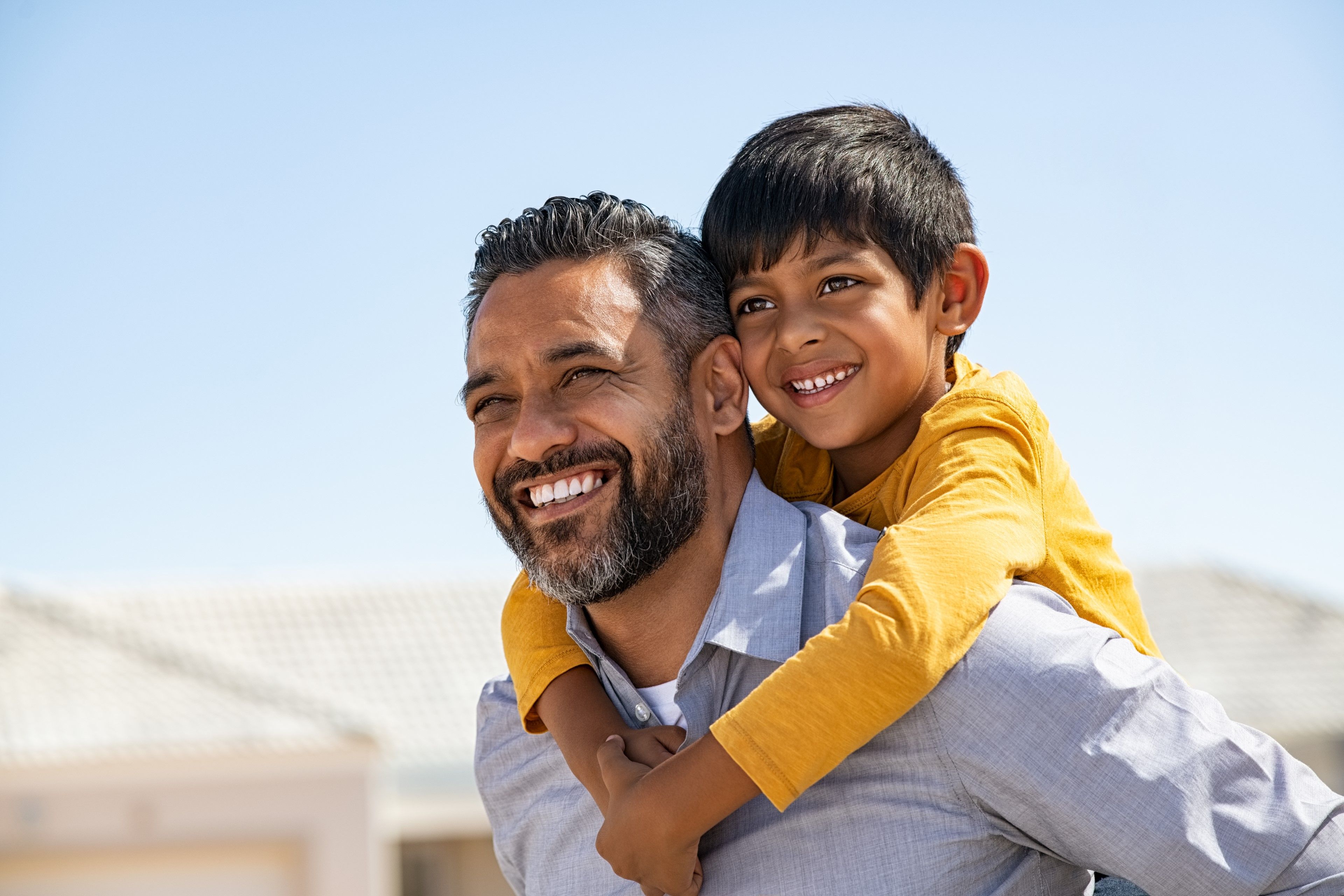 A man with his son on his shoulders